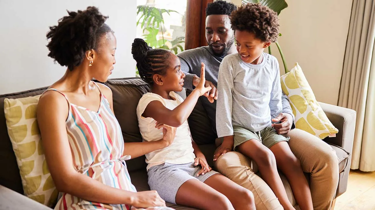 Family Therapy Counselor Talking With Parents and Kids | Pearlman & Associates